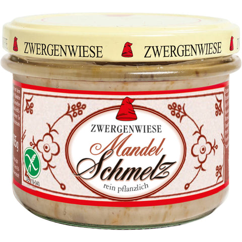 Ein Glas Mandelschmelz, eine cremige und reichhaltige Mandelbutter, perfekt zum Streichen auf Brot oder als Zutat für verschiedene Rezepte. Das Etikett zeigt eine stilvolle Illustration von Mandeln und betont die natürliche und hochwertige Qualität des Produkts.