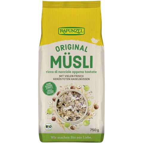 Verpackung des Original Müslis mit einer Mischung aus Haferflocken, Nüssen und getrockneten Früchten, auf einem Holztisch arrangiert.
