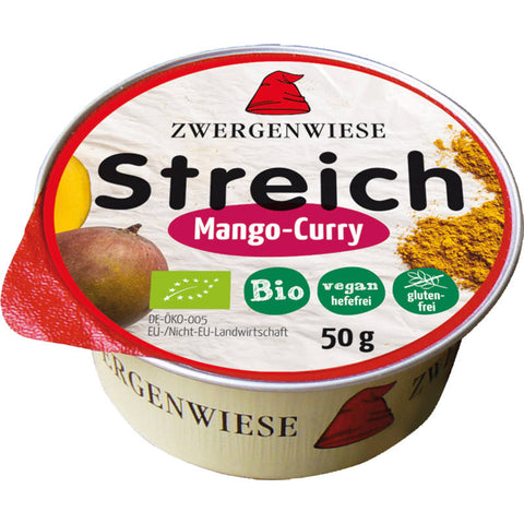 Glas mit Mango-Curry-Aufstrich, leuchtend gelb und cremig, ideal zum Verfeinern von Brot, Crackern oder als Dip.