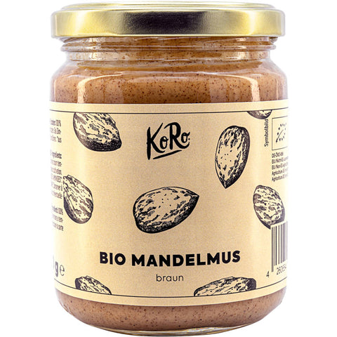 Ein Glas mit braunem Mandelmus, gefüllt mit cremiger, nussiger Paste aus gerösteten Mandeln. Perfekt als Brotaufstrich oder zum Verfeinern von Desserts und Saucen.