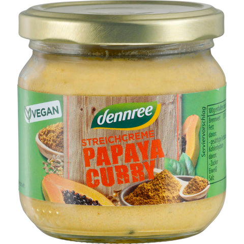 Glas Streichcreme Papaya-Curry mit gelb-orangefarbener Creme, dekoriert mit frischen Papayastücken und Curryblättern.