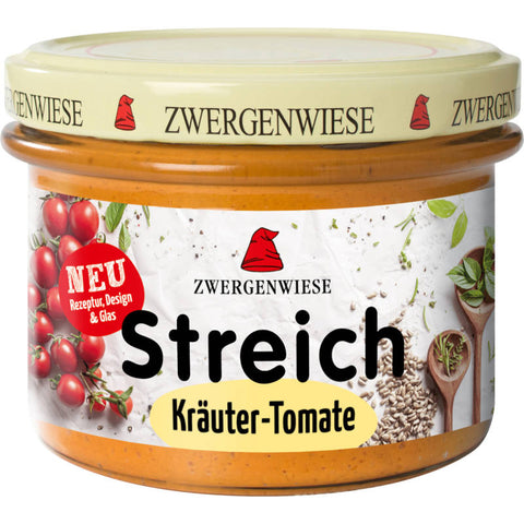 Ein Glas Brotaufstrich mit Kräutern und Tomaten, ideal für ein herzhaftes Frühstück oder als Snack.