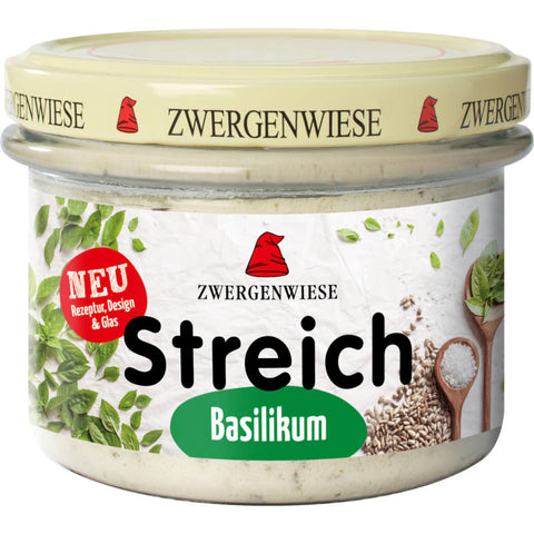 Brotaufstrich mit frischem Basilikum in einem Glasbehälter, ideal für ein aromatisches Frühstück oder als Zutat für kreative Rezepte.