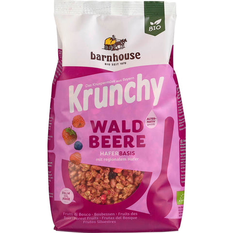 Krunchy Pur Waldbeere Müsli in einer umweltfreundlichen Verpackung, gefüllt mit knusprigen Haferflocken und einer Mischung aus getrockneten Waldbeeren.