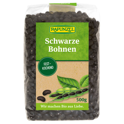 Schwarze Bohnen in einer Schüssel, bereit zum Kochen oder als Zutat für verschiedene Gerichte. Die Bohnen sind glänzend und tiefschwarz, ein vielseitiges und nahrhaftes Lebensmittel.