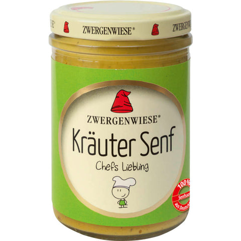 Glas mit Kräuter Senf, gefüllt mit aromatischem Senf, verfeinert mit frischen Kräutern, auf einem rustikalen Holztisch.